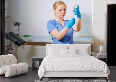 female nurse or doctor's assistant preparing equipm`nt for appointment in medical gynecological clin Wall mural